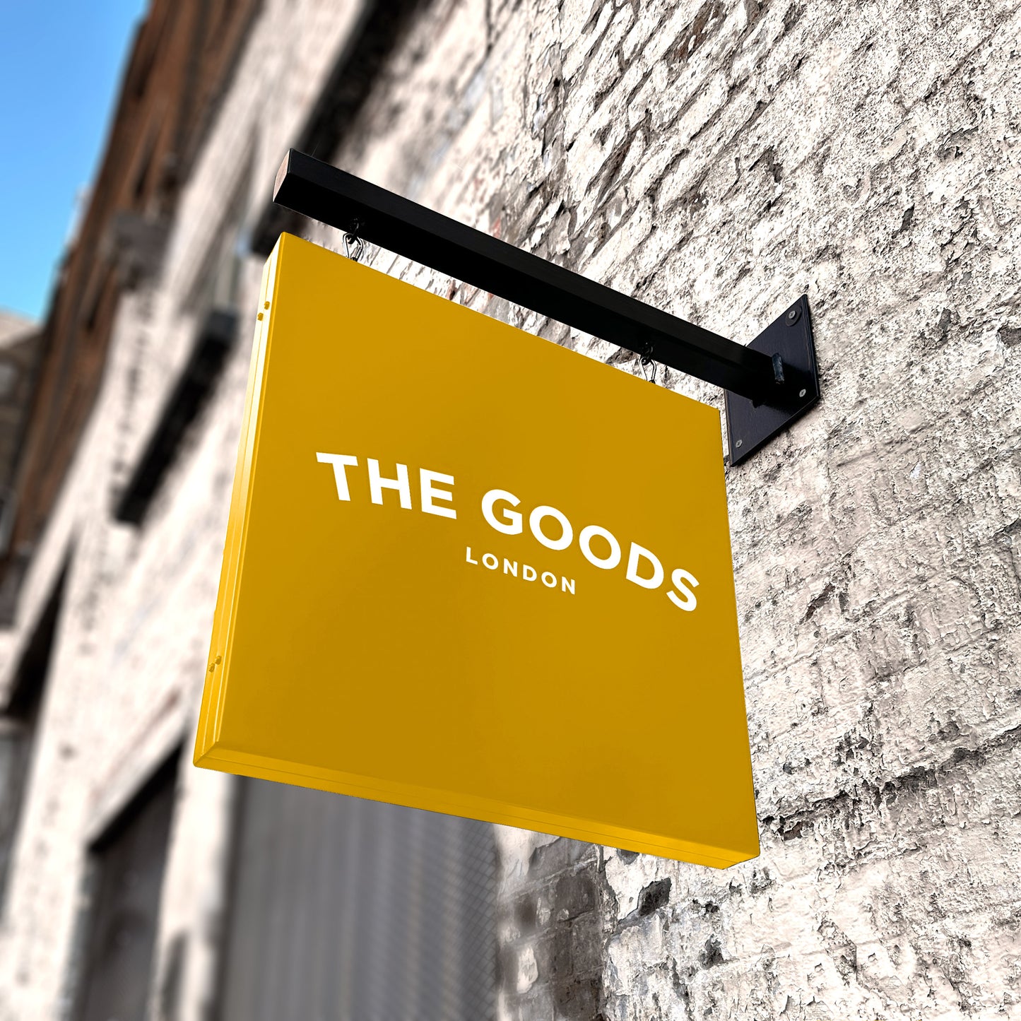 Yellow hanging sign and wall bracket