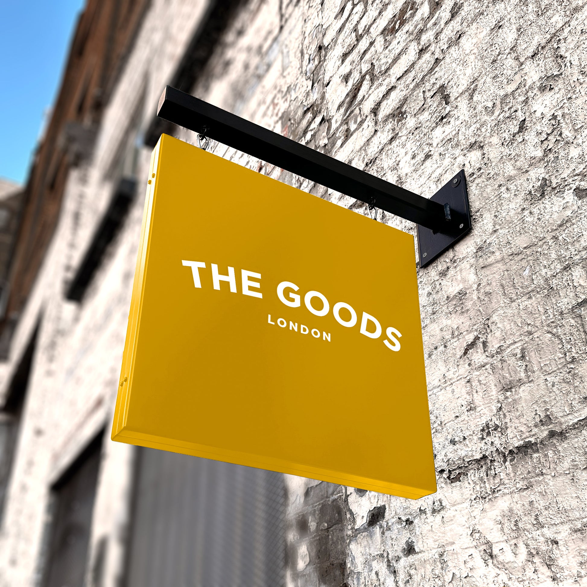 Yellow hanging sign and wall bracket