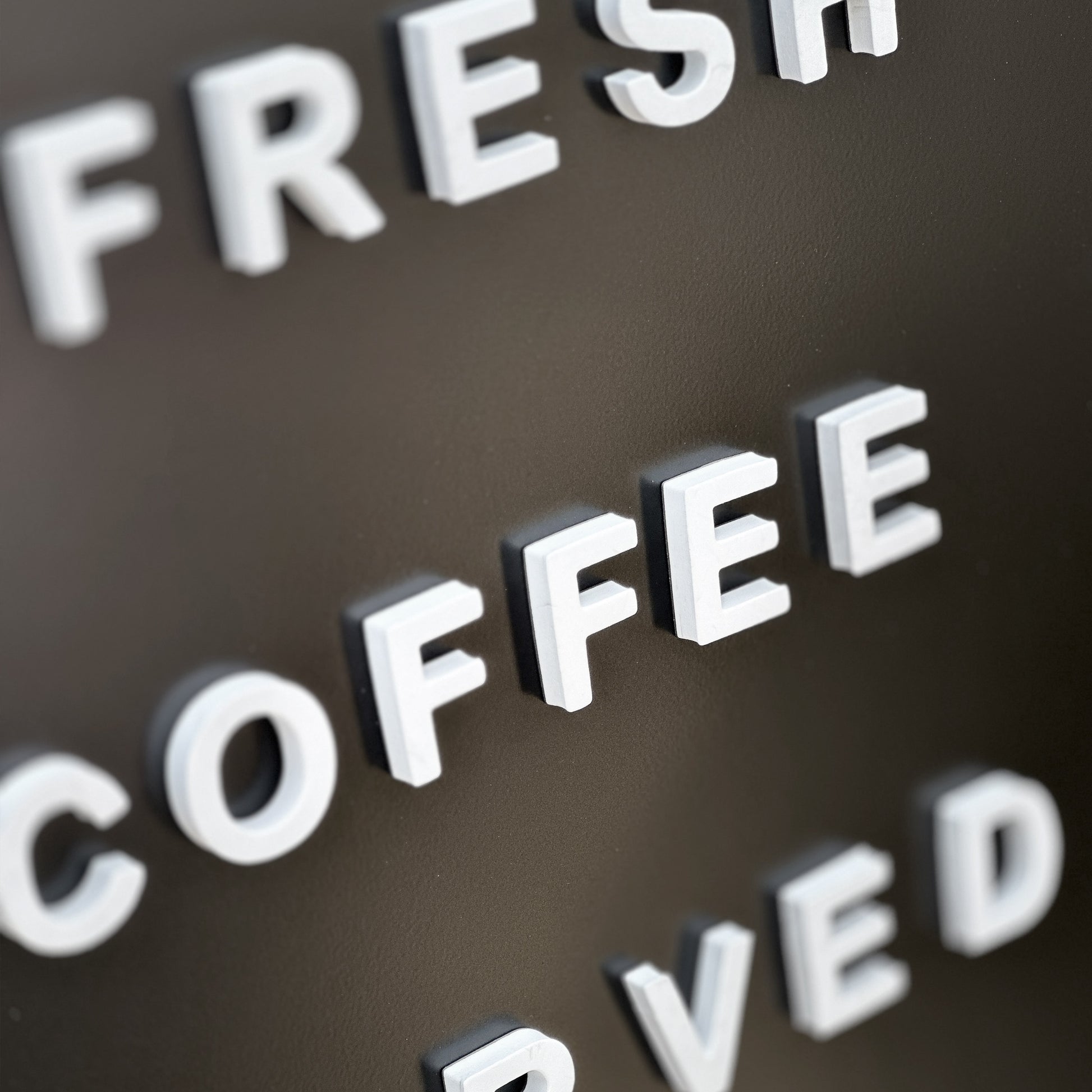 White magnetic letters on black sign