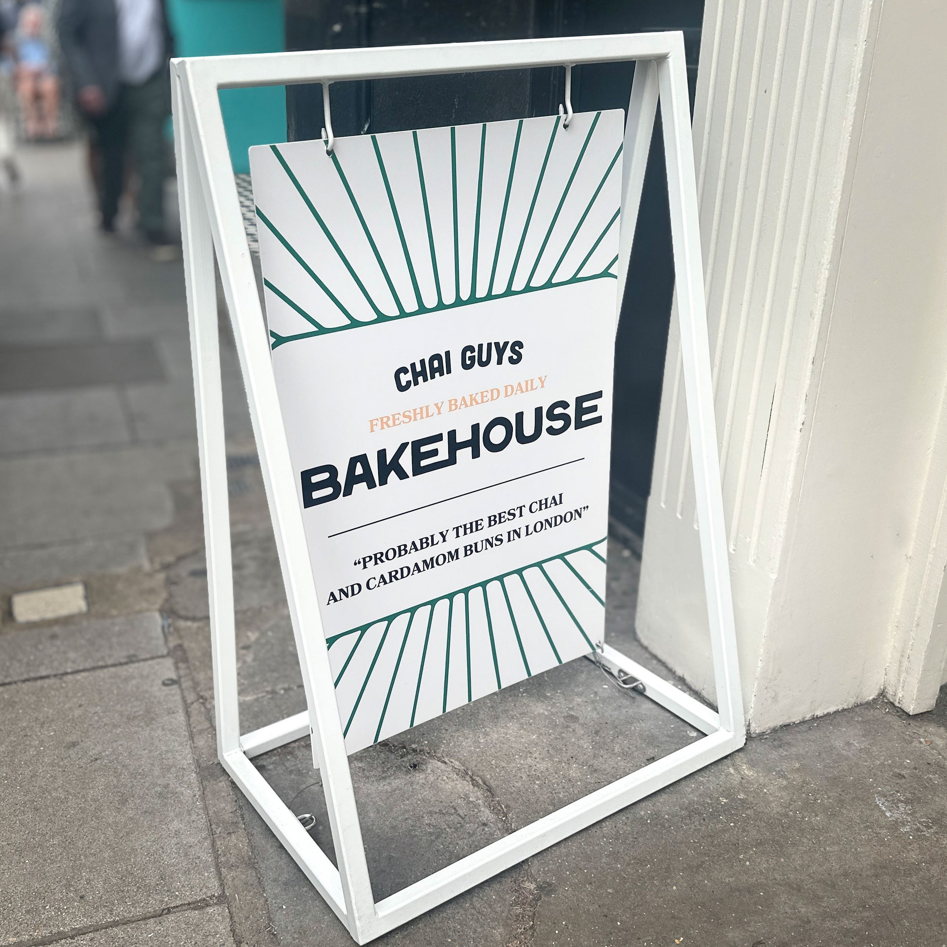 white swinging pavement sign